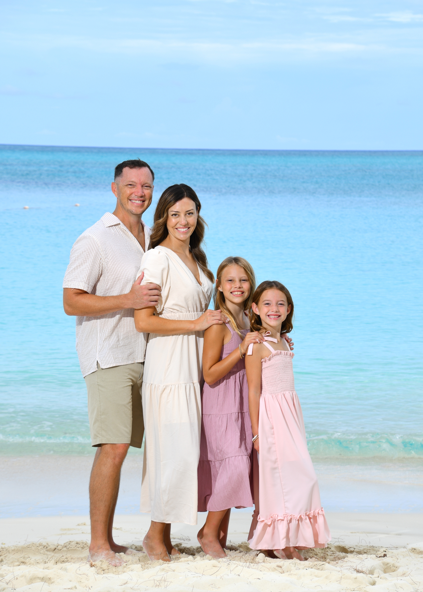 James Chandler on the beach with his wife and two daughters.